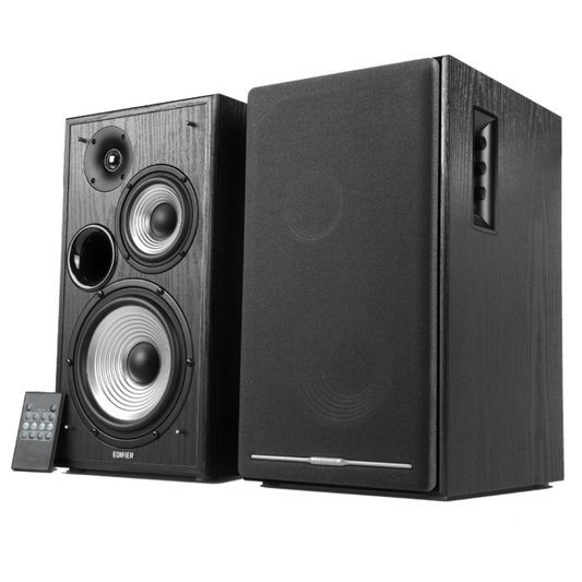 A pair of wood brown Edifier R2750DB bookshelf speakers positioned at an angle to showcase the front and sides, with a black remote control below them, highlighting the speakers' stylish design.
